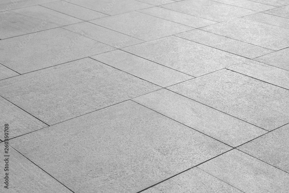 Fototapeta premium Paving stones background. Road texture black and white. Stone flooring. Stone covering on the square.