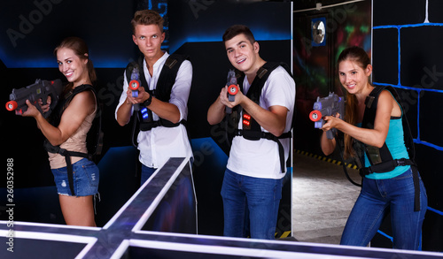 Young team playing laser tag game