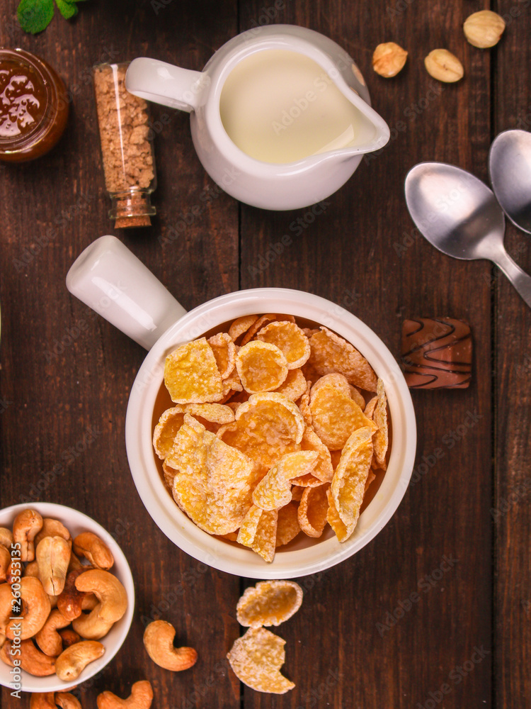cornflakes, coffee, bread, butter, eggs, jam and other ingredients for breakfast on a dark background. Top view with copy space cornflakes, coffee, bread, butter, eggs, jam and other ingredients for breakfast on a dark background. Top view with copy space