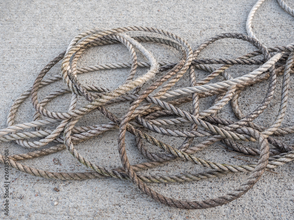 Boat rope on the marina concrete close-up 