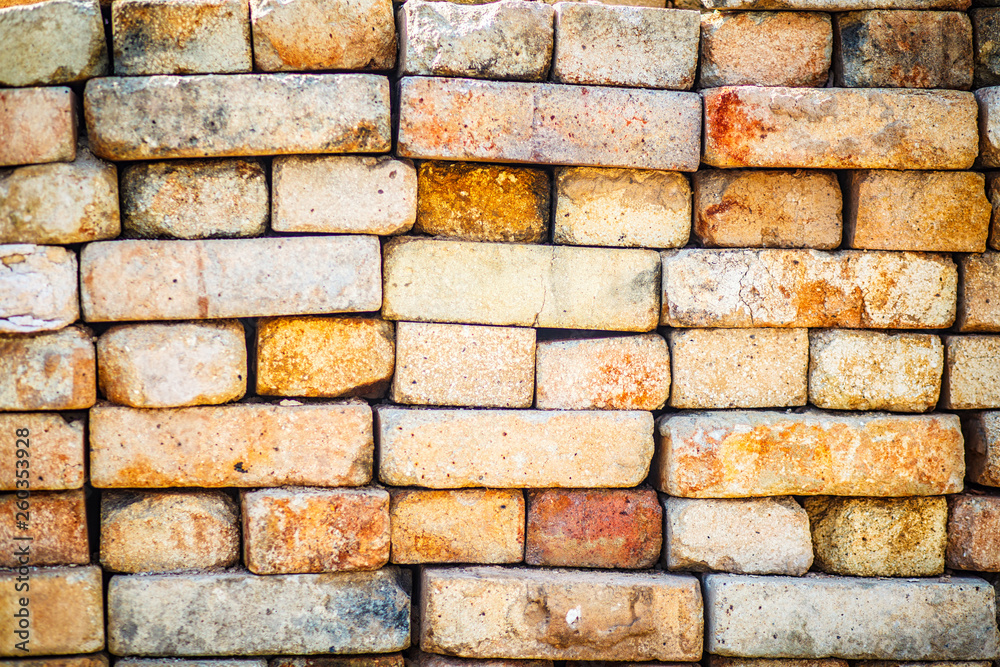 Pallet of paving slab closeup on a construction site in sunny day. Paving slabs in the packaging at the construction site. Brick. Close-up. Pallet of paving slab closeup on a construction site in sunny day. Paving slabs in the packaging at the construction site. Brick. Close-up.