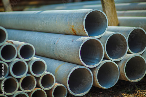 Asbestos Concrete Pipe Stacked For use in construction. In the drainage or water supply section. Stack of pipes. Sewage Drainage Concrete Pipeline, Materials for construction at work on concrete roads