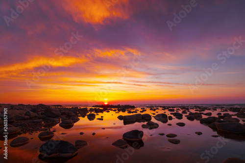 Beautiful sunset at sea side with stones