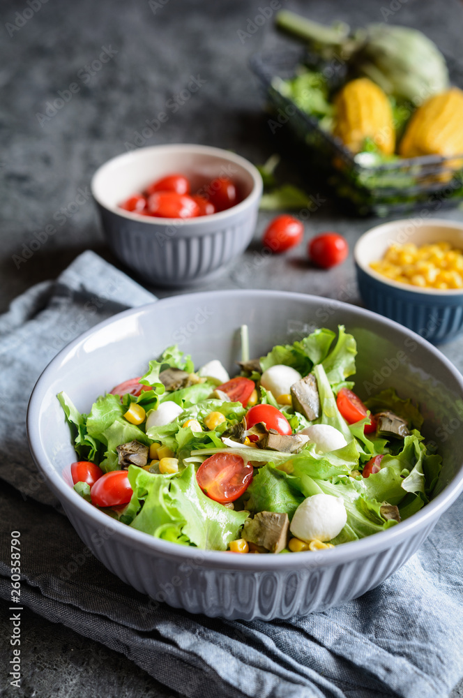 Healthy salad with baked artichoke, Mozzarella, tomatoes and corn