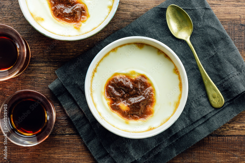 Turkish rice pudding on a wooden table, top view Turkish rice pudding on a wooden table, top view