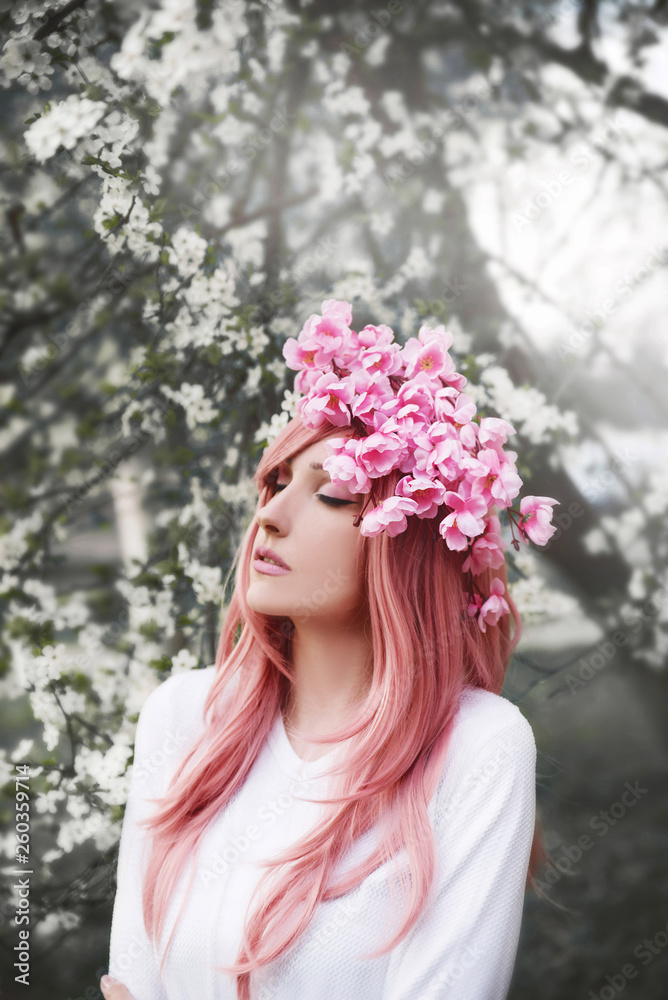 Fototapeta premium Young woman with pink wearing flower crown hair in nature