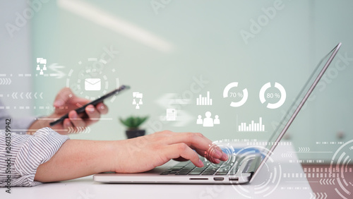 close up businessman hand working on laptop with financial data dashboard for technology concept photo