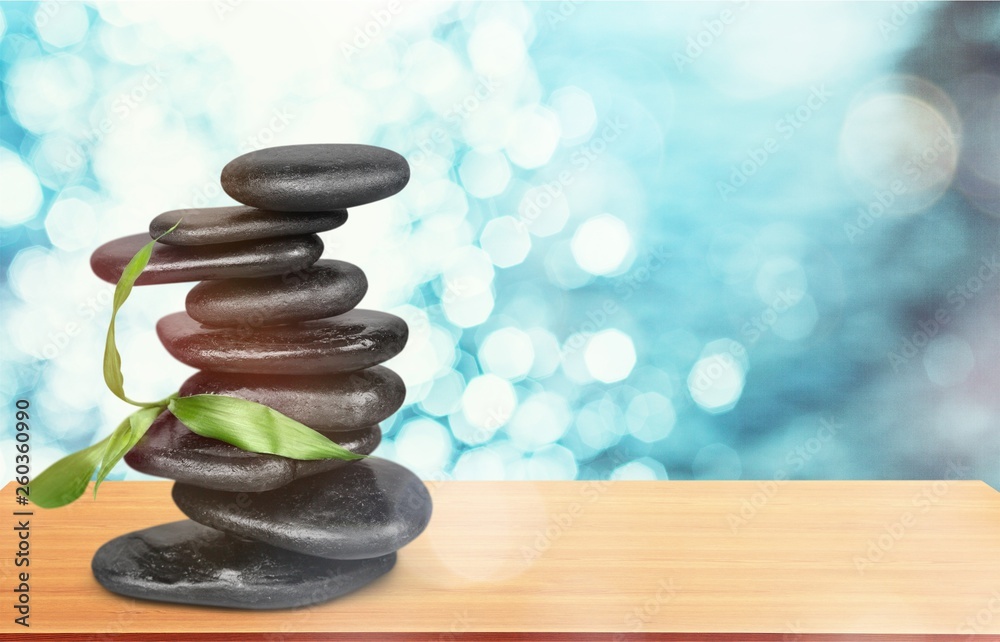 Zen basalt stones and leaves on background Zen basalt stones and leaves on background