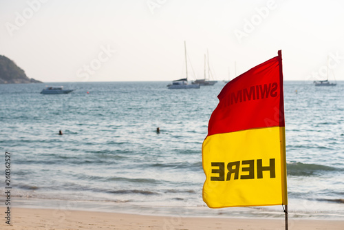 Flag "Swim here" against the sea
