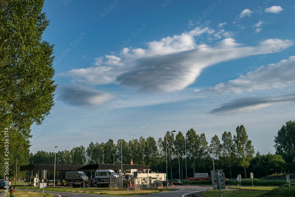 Lenticular clouds resembling UFOs, formed in the wake of thunderstorms over The Netherlands. Lenticular clouds resembling UFOs, formed in the wake of thunderstorms over The Netherlands.