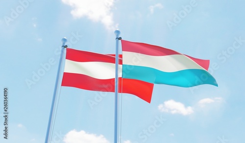 Austria and Luxembourg, two flags waving against blue sky. 3d image