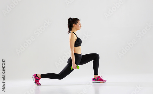 happy young woman doing fitness sports on white