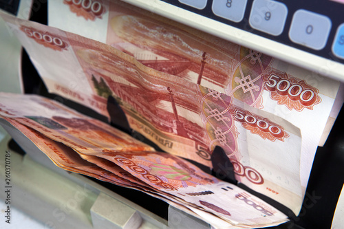 electronic money counter machine is counting the Russian five-thousandth ruble banknotes