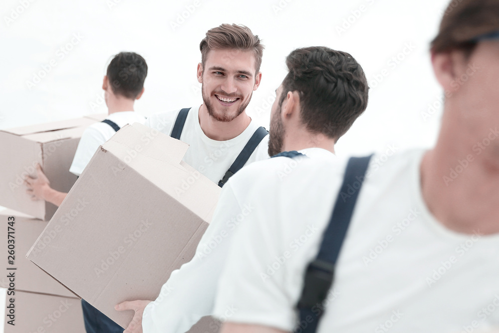 Photo workers pass each other boxes when moving flats. Photo workers pass each other boxes when moving flats.