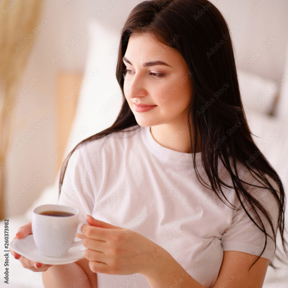 woman enjoying a cup of coffee in early morning woman enjoying a cup of coffee in early morning