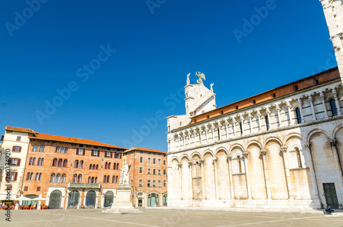 Chiesa di San Michele in Foro St Michael Roman Catholic church basilica on Piazza San Michele square in historical centre of old medieval town Lucca in summer day with clear blue sky, Tuscany, Italy