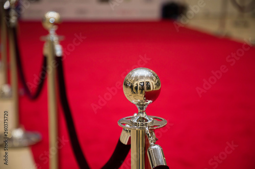 Red carpet with barriers and velvet ropes.