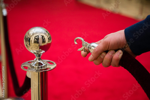 Red carpet with barriers and velvet ropes.
