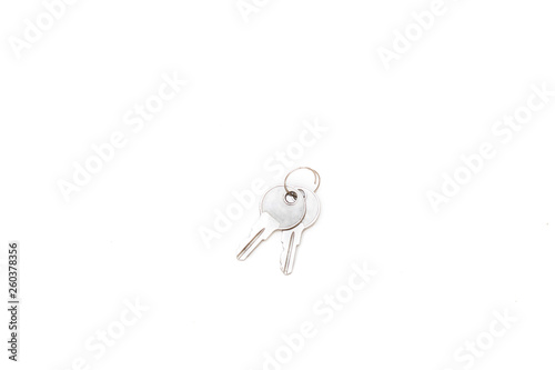 Two small silver keys on a white background