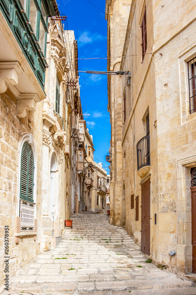 Beautiful narrow lane with typical Maltese architecture in Cospicua - one of the Three fortified Cities of Malta