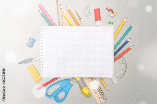 Colorful school supplies on wooden background