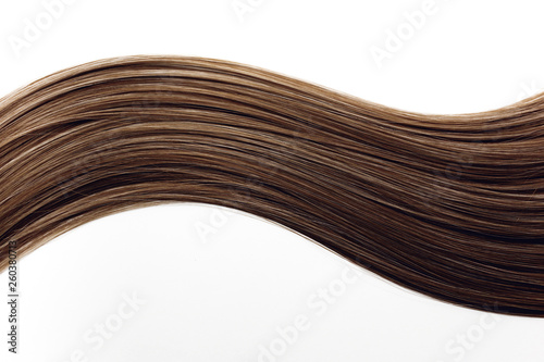 Piece of beautiful, shiny, dark brown, chestnut hair on white isolated background. Wavy shape. Hair color ideas