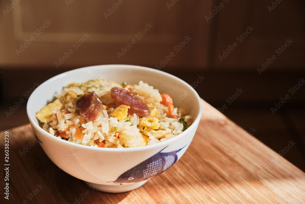 A Bowl of Chinese Fried Rice with Pork Sausages and vegetables. A Bowl of Chinese Fried Rice with Pork Sausages and vegetables.
