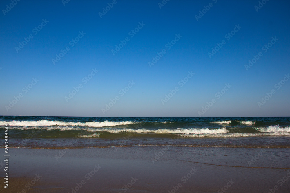 Sea waves and sandy beach