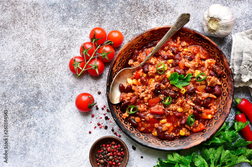 Chili con carne - minced meat stew with red bean and tomato.Traditional dish of mexican cuisine.Top view with copy space. photo