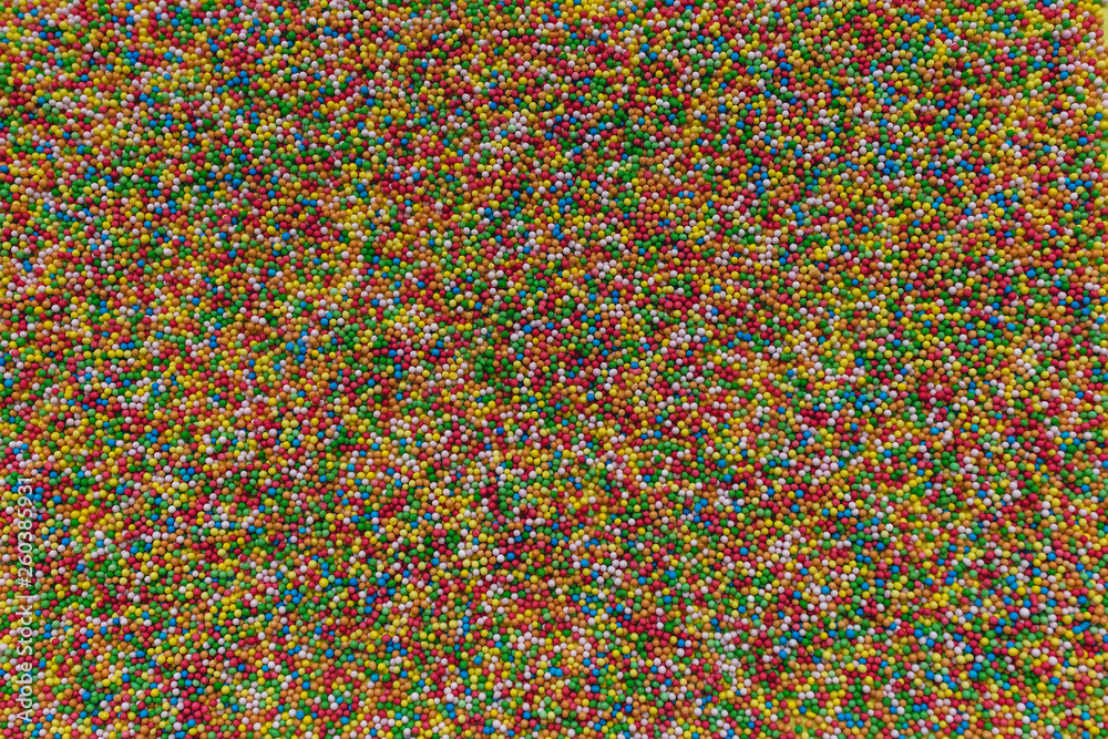 Colorful rainbow sprinkles background.