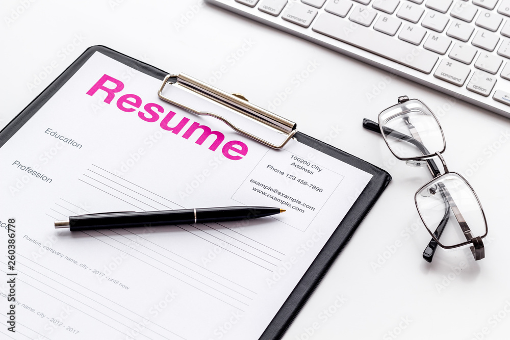 Review resumes of applicants set with keyboard and glasses white work desk background Review resumes of applicants set with keyboard and glasses white work desk background