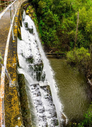 Water flowing over the dam at Searsville Lake located in Jasper Ridge Biological Preserve, San Francisco bay area, California photo