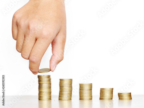 Hand stacking coin on desk, Invest your money to get in come,growing business and future concept