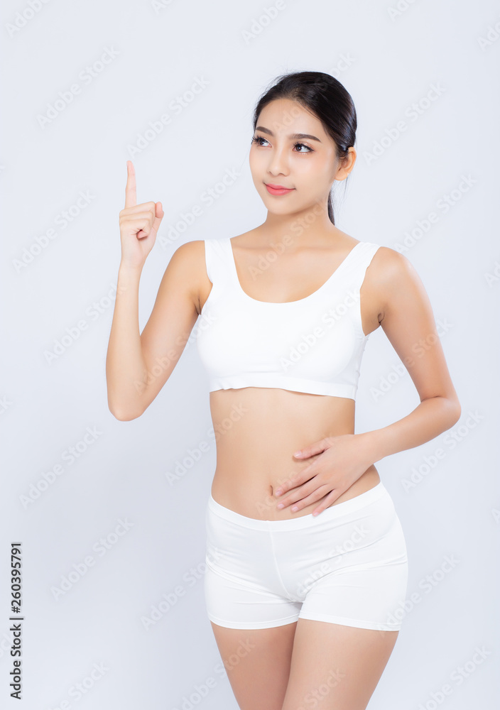 Portrait young asian woman smiling beautiful body diet with fit and finger pointing something isolated on white background, model girl weight slim with cellulite, health and wellness concept. Portrait young asian woman smiling beautiful body diet with fit and finger pointing something isolated on white background, model girl weight slim with cellulite, health and wellness concept.