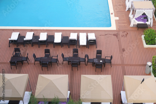 high angle view of beach chairs at the side of swimming pool