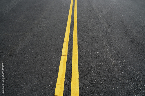 double yellow lines on new paved asphalt road surface © nd700