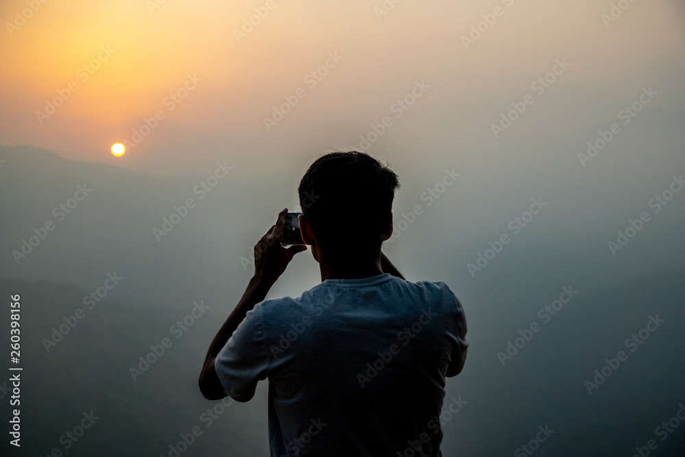 man taking pictures on mobile phone