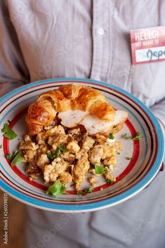 Lush croissant with chicken, soft cream cheese and scramble photo