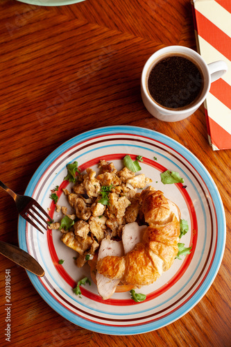 Lush croissant with chicken, soft cream cheese and scramble photo