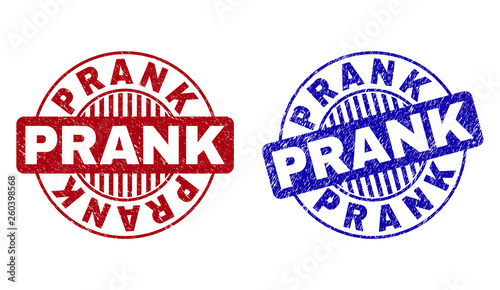 Grunge PRANK round stamp seals isolated on a white background. Round seals with grunge texture in red and blue colors. Vector rubber imprint of PRANK caption inside circle form with stripes.
