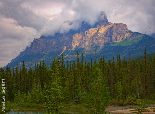 Castle Mountain at sunrise with an incredible golden color. Rocky mountain ( Canadian Rockies ). Near the city of Calgary. Portrait, fine art. Banff National Park, Alberta, Canada: August 4, 2018