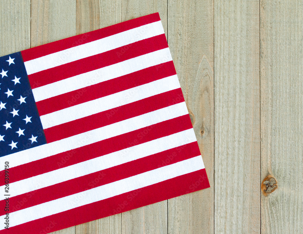 Obraz premium a small American flag on a wood background with copy space