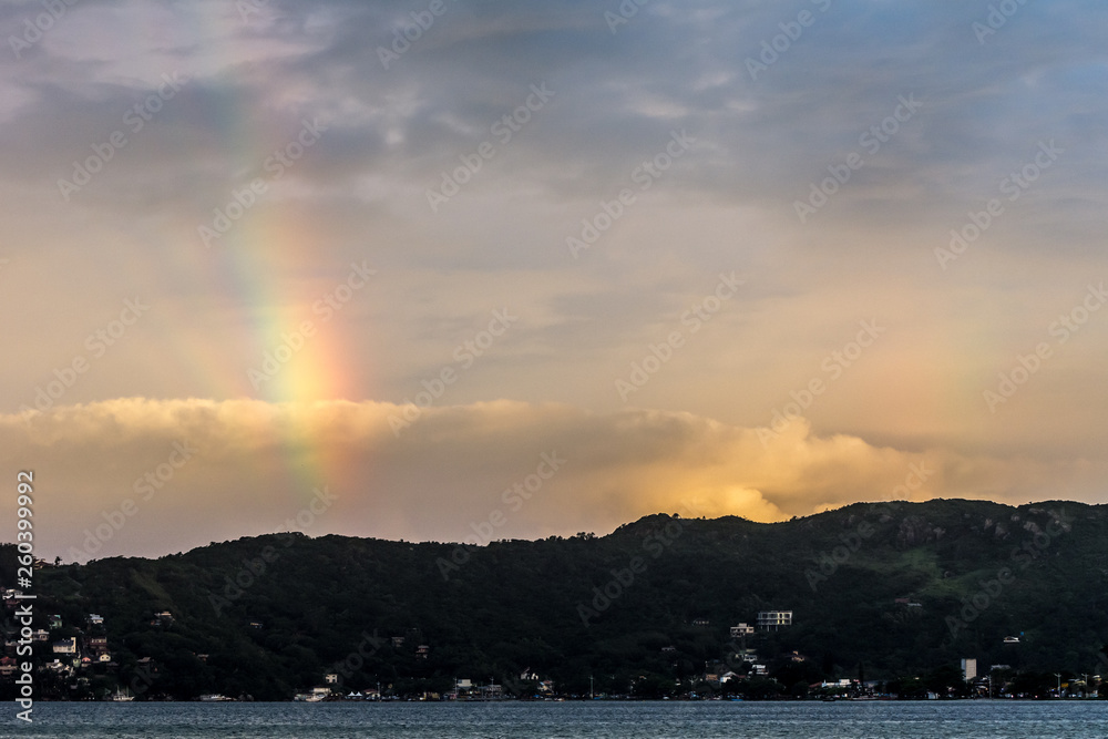 Fantastic sky with rainbow at the Caonceicao Lagoon, in Florianopolis, Brazil.
