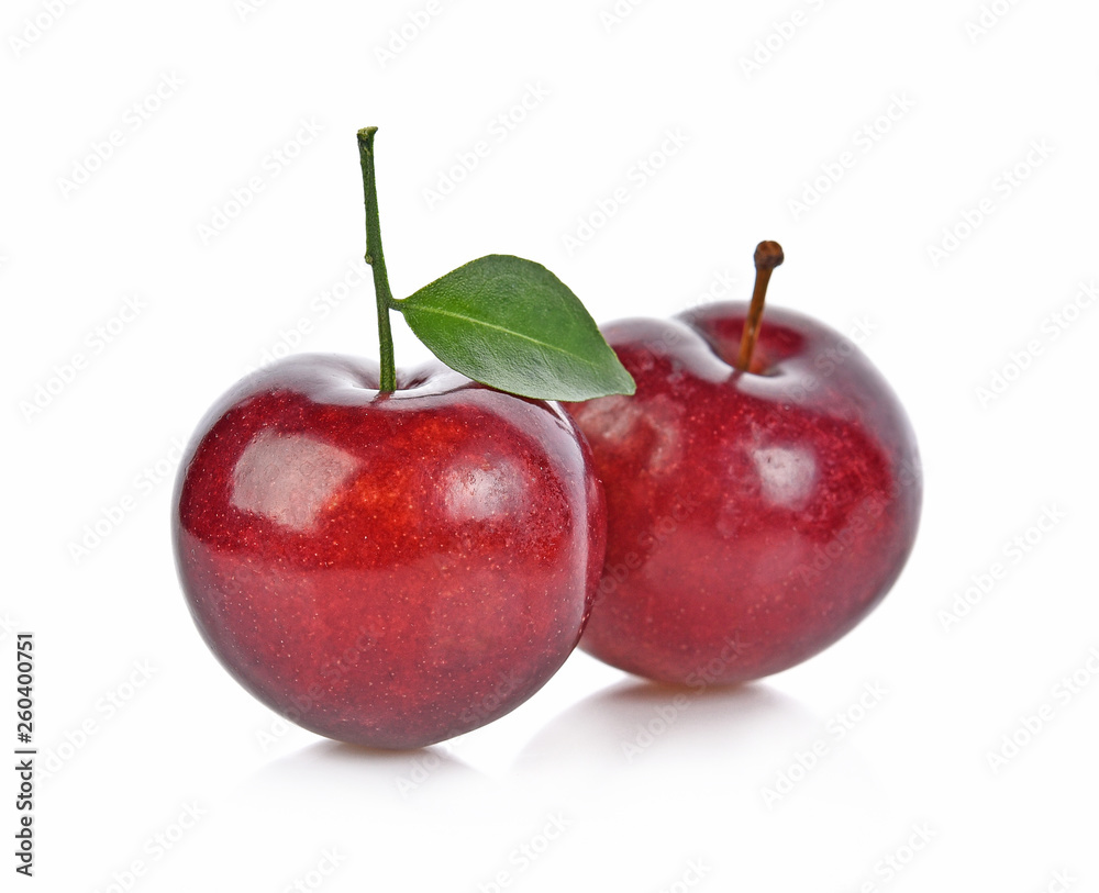 Red cherry plum with green leaves isolated on white background
