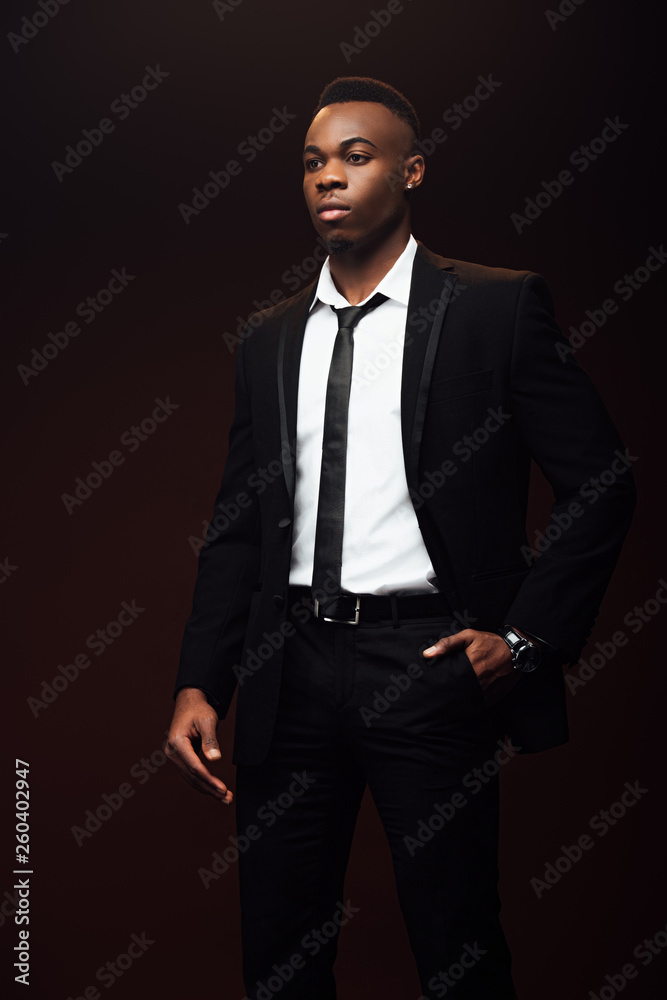 handsome fashionable african american man in suit looking away isolated on black handsome fashionable african american man in suit looking away isolated on black