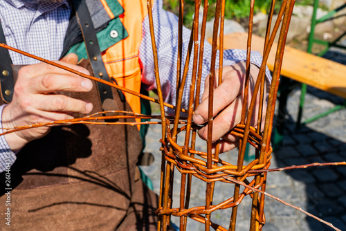 Close-up of a man weaving a basket