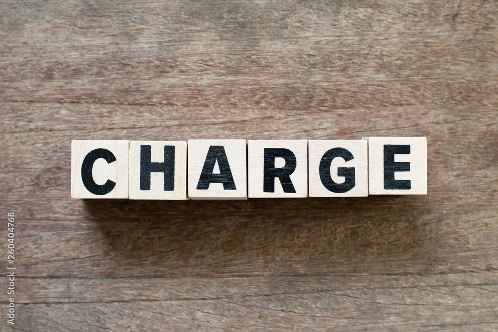 Fototapeta premium Letter block in word charge on wood background