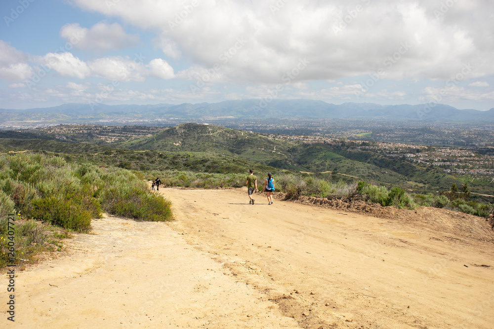 People hiking at Aliso & Woods Canyon Wilderness trail in the spring after a rainy season, Laguna Beach, CA hiking trails.