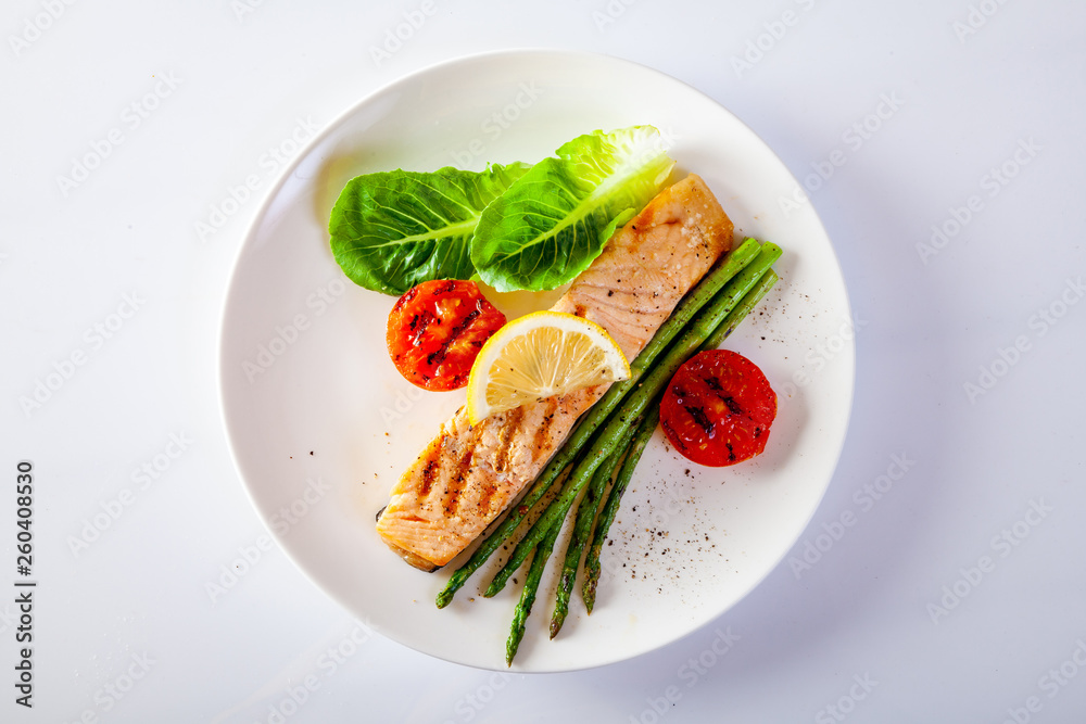 Roasted salmon steak with asparagos tomatoes  with fresh vegetable.