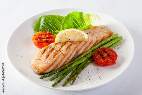 Roasted salmon steak with asparagos tomatoes with fresh vegetable.